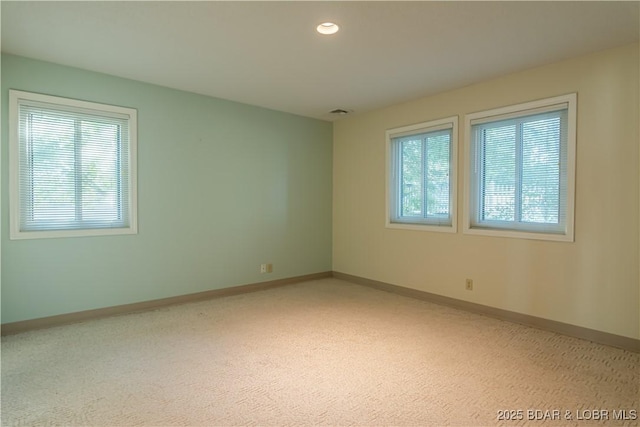 carpeted empty room featuring plenty of natural light