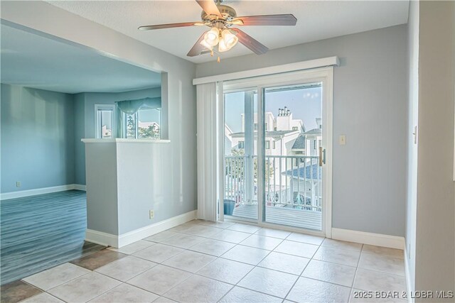 empty room featuring ceiling fan and light tile patterned floors