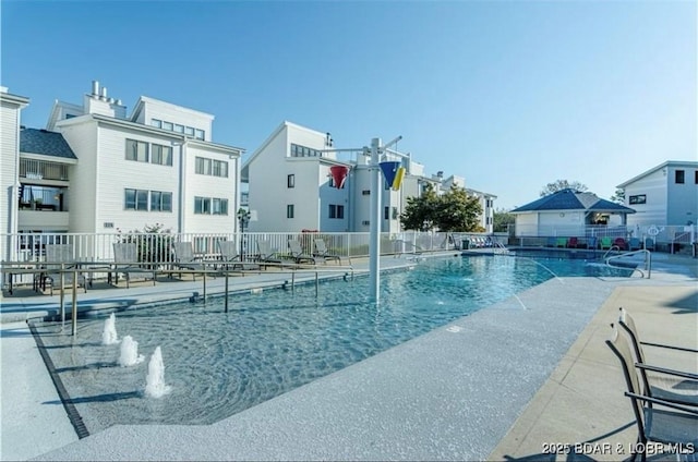 view of pool with pool water feature and a patio