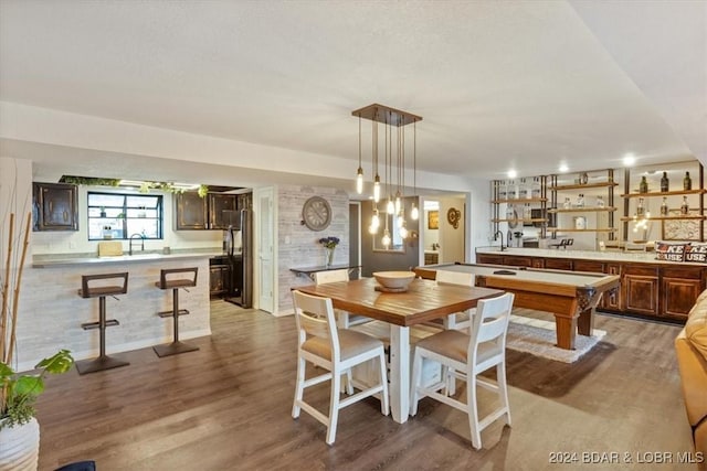 dining space featuring sink, pool table, and light hardwood / wood-style flooring