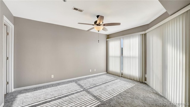 spare room featuring ceiling fan and light carpet