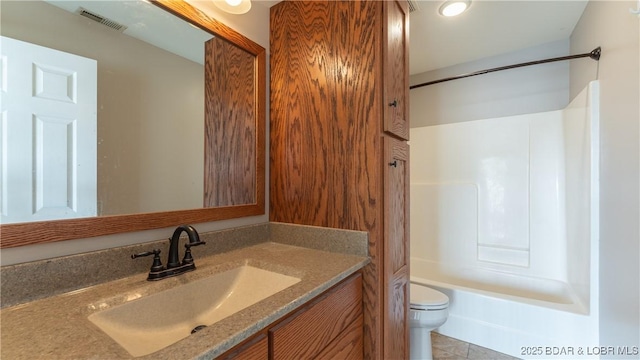 full bathroom featuring tile patterned flooring, vanity, toilet, and shower / tub combination