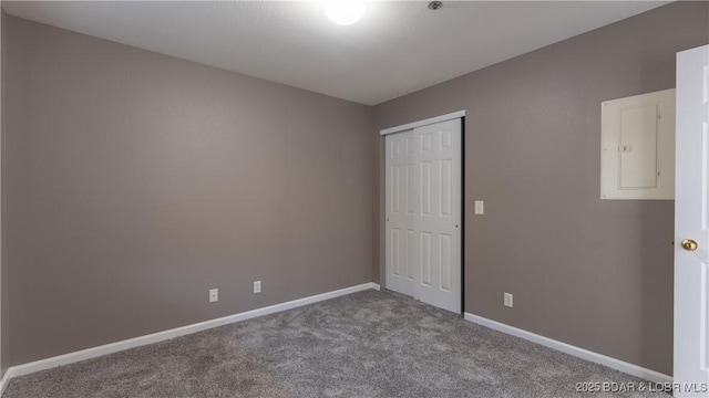 unfurnished bedroom featuring carpet and a closet