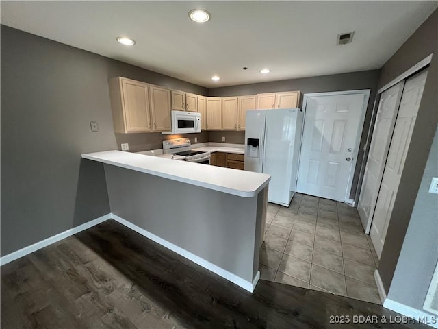 kitchen with white appliances and kitchen peninsula