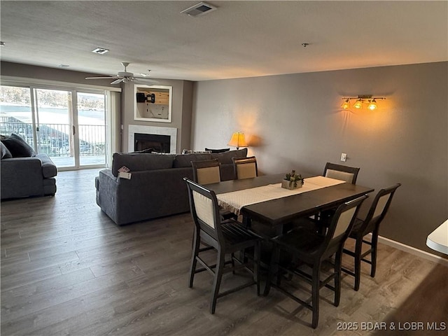 dining space with ceiling fan and dark hardwood / wood-style floors