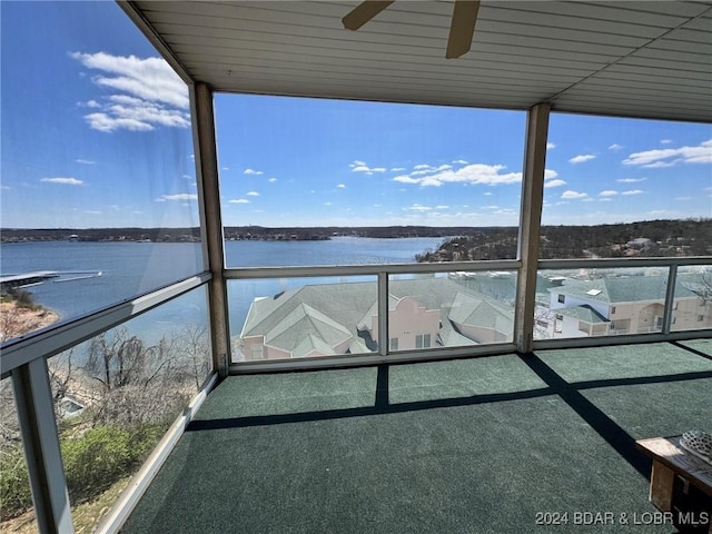 exterior space featuring ceiling fan and a water view