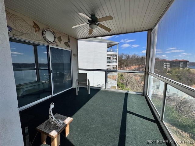 unfurnished sunroom featuring a wealth of natural light and ceiling fan