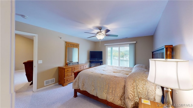 bedroom featuring access to outside, light colored carpet, and ceiling fan