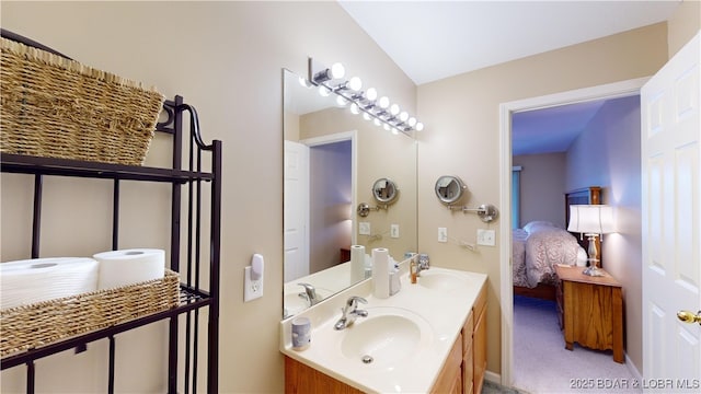 bathroom with vanity and vaulted ceiling