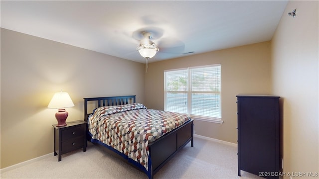 bedroom with ceiling fan and light colored carpet