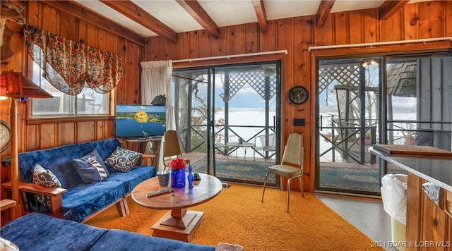 living room featuring wood walls and beam ceiling