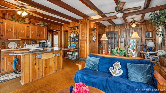 kitchen with wood walls, beamed ceiling, light carpet, and white stove