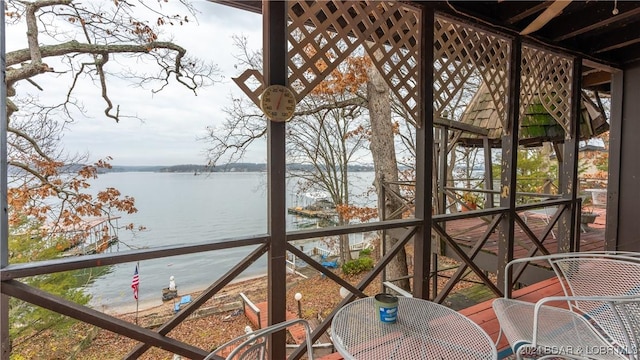 unfurnished sunroom with a wealth of natural light and a water view