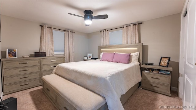 bedroom featuring ceiling fan, light carpet, and a closet