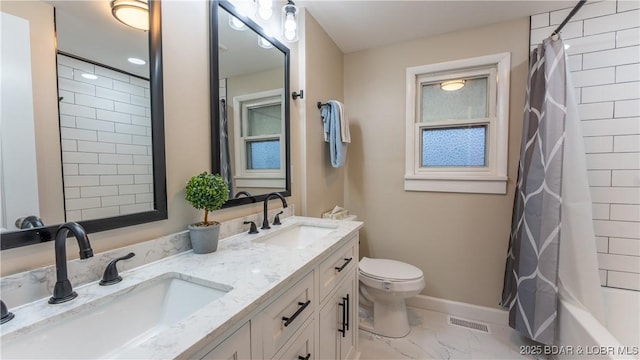 full bathroom with shower / bath combo with shower curtain, vanity, and toilet