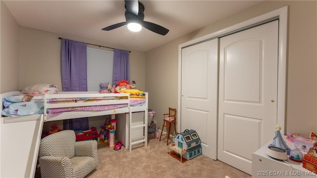 bedroom with light carpet, a closet, and ceiling fan