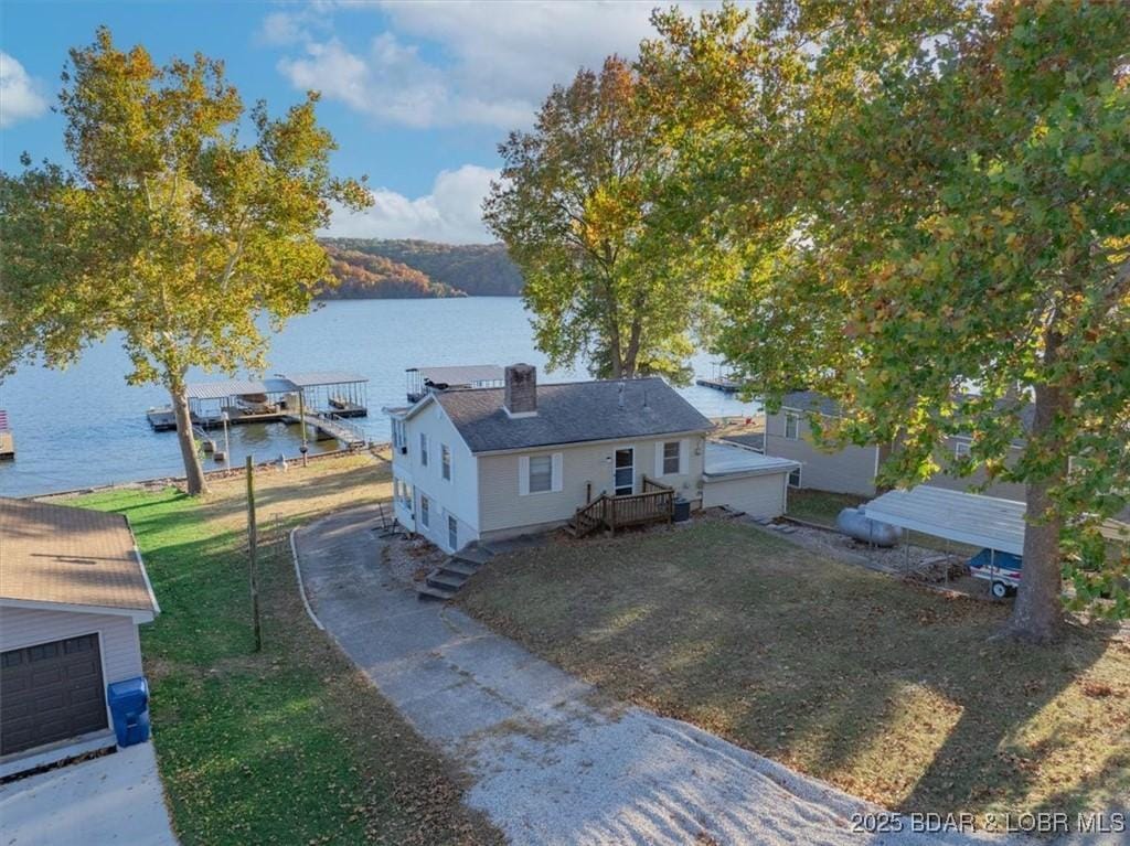 exterior space featuring a deck with water view and a front yard