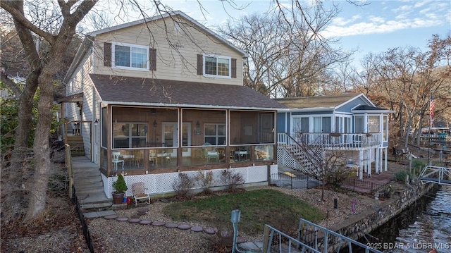 back of house featuring a sunroom