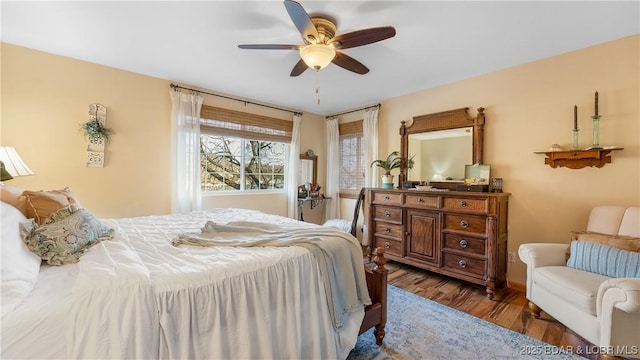 bedroom featuring ceiling fan and dark wood-type flooring