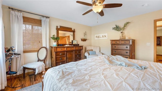 bedroom with hardwood / wood-style flooring and ceiling fan