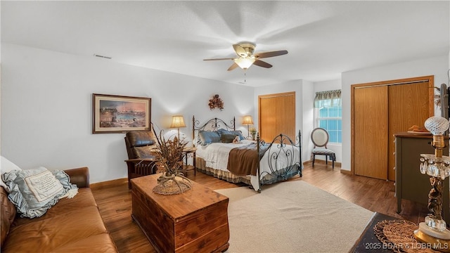 bedroom featuring ceiling fan, a closet, and hardwood / wood-style flooring