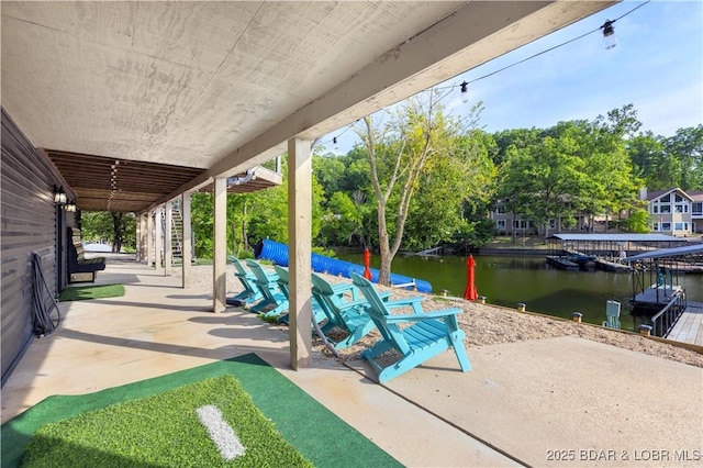 view of patio featuring a water view and a dock