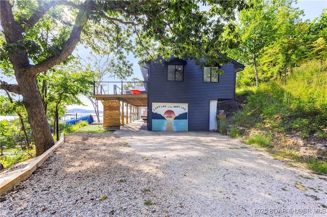 view of front of property with a wooden deck and a garage