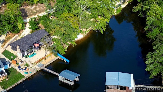 birds eye view of property with a water view