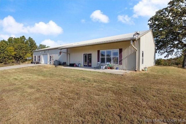 back of property with a patio and a yard