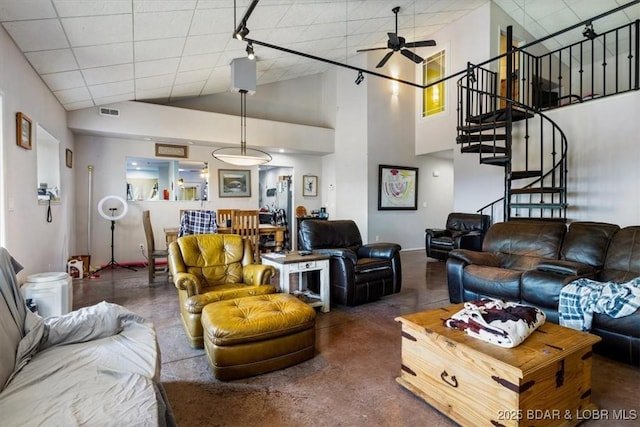 living area featuring visible vents, high vaulted ceiling, stairway, and a ceiling fan