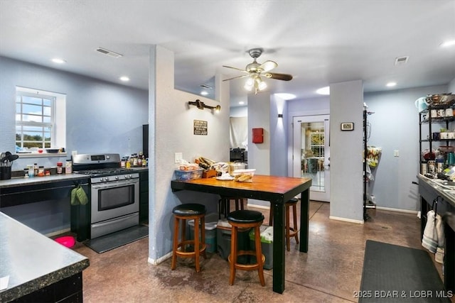 kitchen with recessed lighting, light countertops, visible vents, and gas range