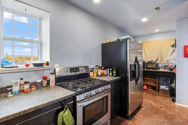 kitchen featuring a textured wall, appliances with stainless steel finishes, visible vents, and recessed lighting