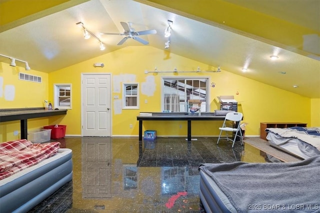 recreation room with visible vents, granite finish floor, a ceiling fan, vaulted ceiling, and baseboards