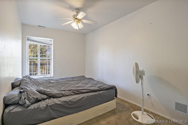 carpeted bedroom with baseboards, visible vents, and ceiling fan