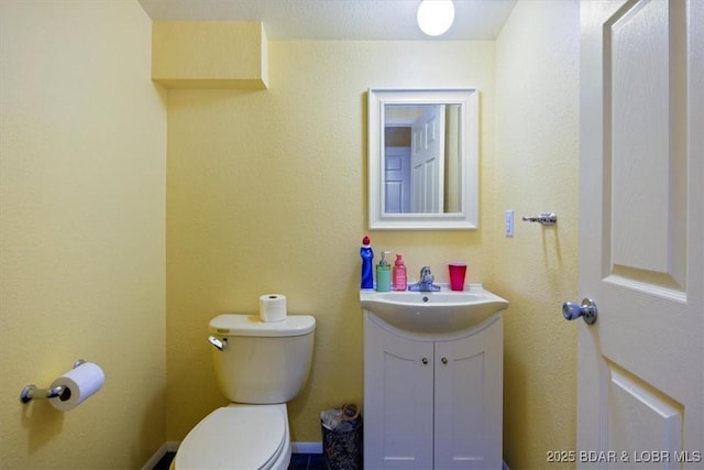 bathroom with toilet and vanity