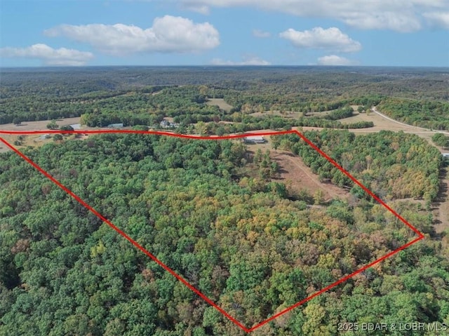 drone / aerial view featuring a forest view