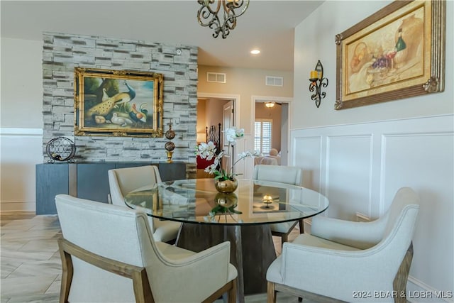 tiled dining space with a chandelier