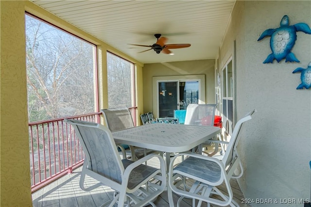 sunroom / solarium featuring ceiling fan