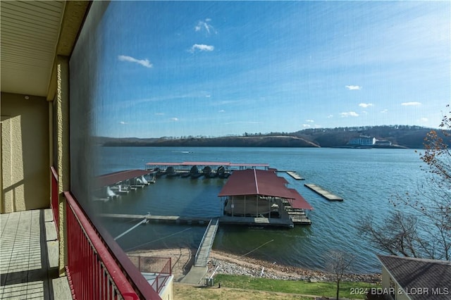 view of dock featuring a water view and a balcony