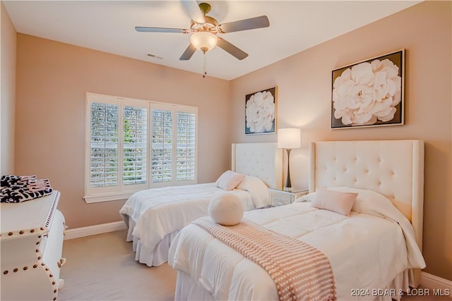 bedroom featuring light carpet and ceiling fan