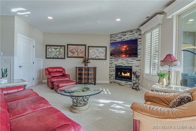 carpeted living room featuring a fireplace and plenty of natural light