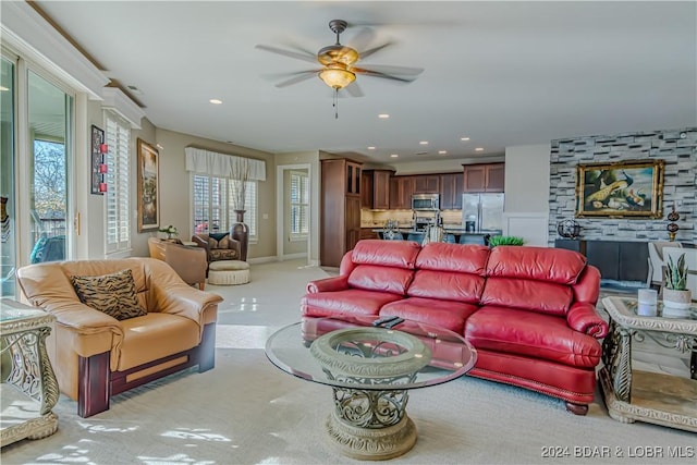 living room with ceiling fan and plenty of natural light