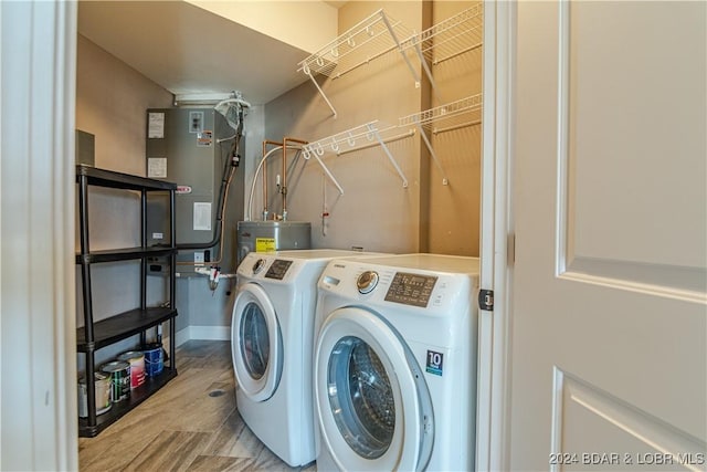 laundry room featuring washing machine and dryer, gas water heater, and water heater