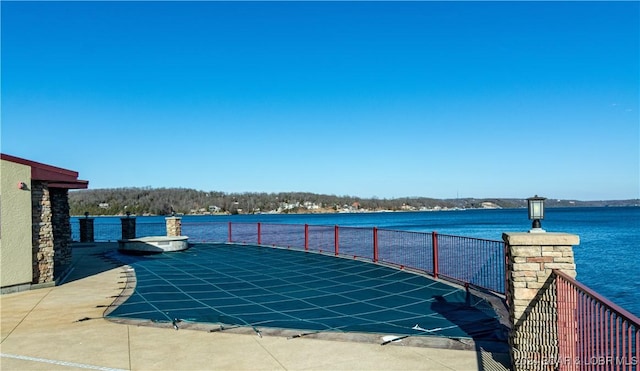 view of pool featuring a water view