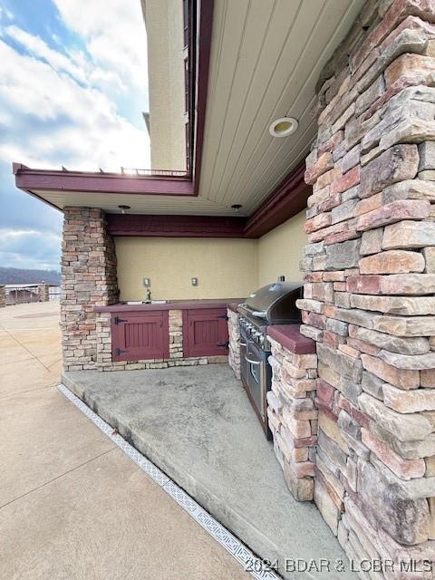 view of patio featuring area for grilling and sink