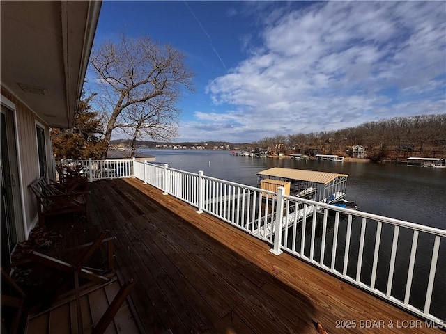 wooden deck with a water view and a boat dock