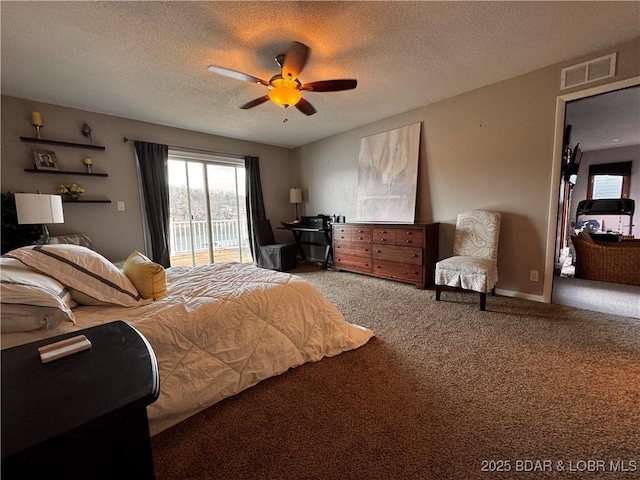 carpeted bedroom with access to exterior, visible vents, a textured ceiling, and multiple windows