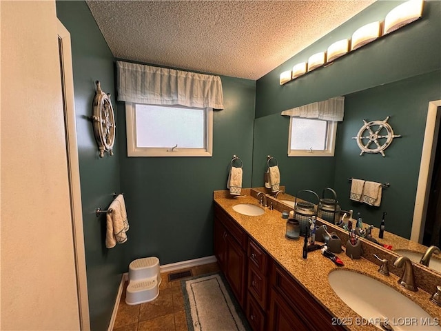 full bathroom featuring visible vents, a sink, a textured ceiling, and double vanity