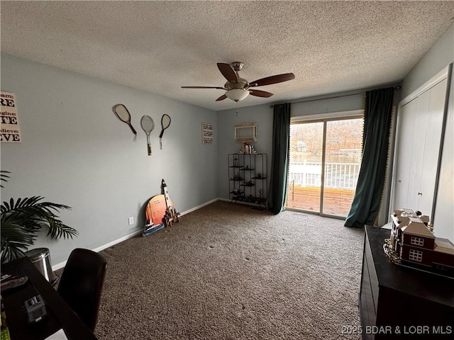 interior space with carpet floors, a textured ceiling, baseboards, and a ceiling fan