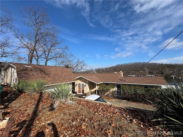 back of property featuring a chimney